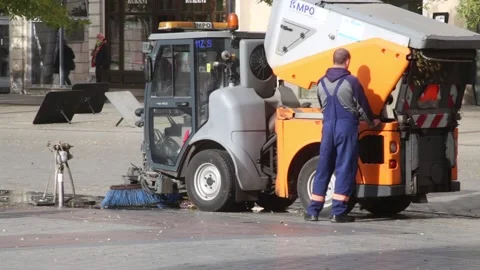 Driver of a street sweeper car maintaining its machinery. 3609 Stock Footage 142998053