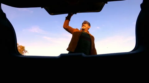 The driver takes an object from the luggage compartment - 4k - ProRes Stock Footage 142364907
