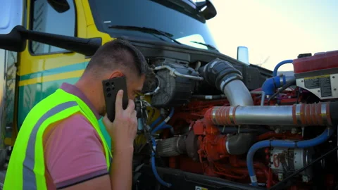 The driver is talking by phone about the problem with semi truck. Wide view Stock Footage 296921928