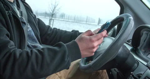 Driver is texting when driving a car Stock Footage 60975235