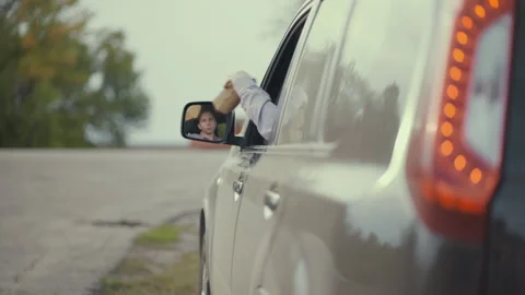 Driver throwing away hamburger box from car window on road. Stock Footage 138968200