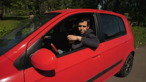 Driver throws out a used paper cup from the window car 스톡 동영상 130528405