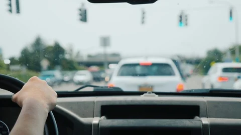 The driver is in traffic, in the frame his hands on the steering wheel and Stock Footage 119270475