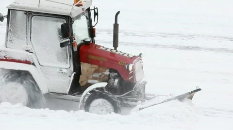 Driver on traktor clears road of snow in winter Stock Footage 751684