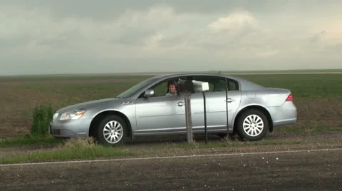 Driver Tries to Pick Up Mail During Hail Storm Stock Footage 54746103