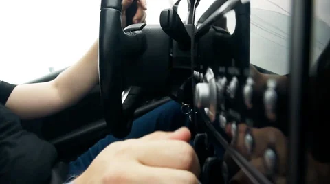 Driver tuning radio in car Stock Footage
