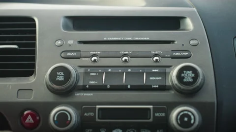 Driver turning on car and increasing volume on stereo dashboard control panel Stock-Footage 310183190