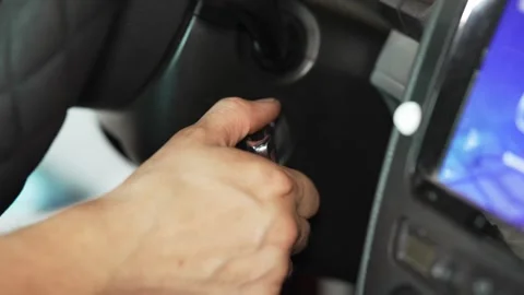 Driver turning the ignition key to start a car engine. Stock Footage 341487535