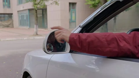 The driver unfolds the left side mirror by hand. Stock Footage 329165846