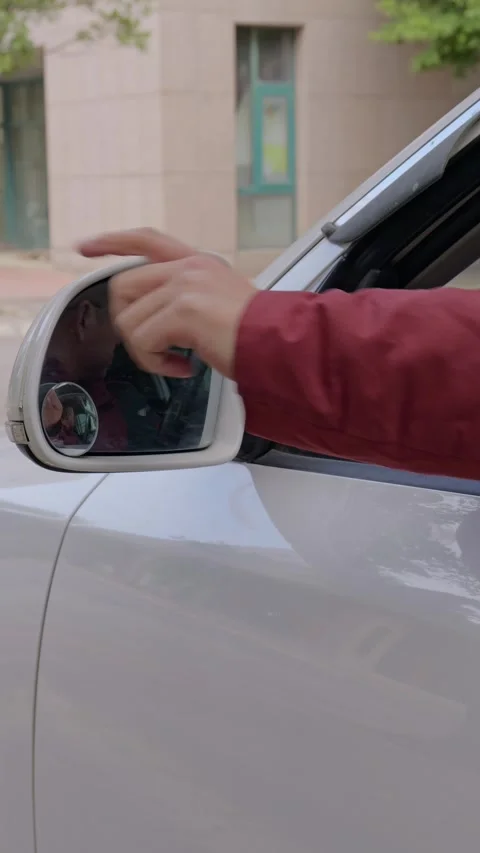The driver unfolds the left side mirror by hand. Stock Footage 329397828
