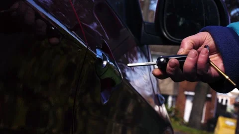 Driver unlocking and opening car door Видео 332653416