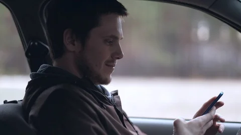 Driver use smartphone, sitting in the car. Stock Footage 107090220