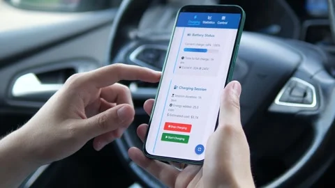 A driver uses an app to start an EV charging session, with visuals of progress Stock Footage 315090973