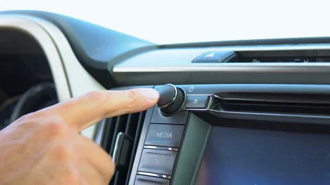 The driver uses the audio system. Stockbeeldmateriaal 92842410