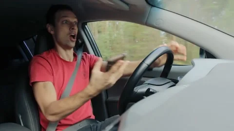 Driver uses mobile phone to read message and drive speed while driving on road Stock Footage 145404852