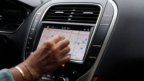 Driver using car navigation system Stock Footage 120509332