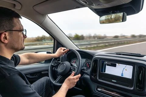 Driver Using Dashboard Navigation On Highway Road Trip Stock Photos