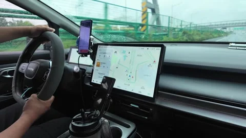 Driver Using Digital Navigation System Inside Car on Rainy Highway in China Stock Footage 336171391