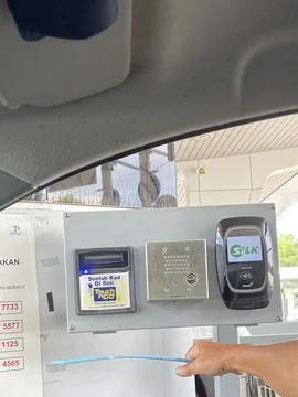 Driver Using Electronic Toll Payment System at Highway Booth Stock Photos