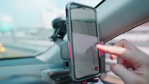 Driver using GPS navigation in smart phone while driving car Stock Footage 148363644