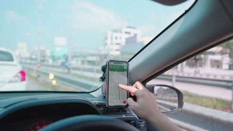 Driver using GPS navigation in smart phone while driving car 스톡 동영상 148363658