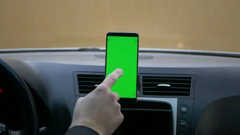 Driver using mobile mobile green screen chroma key while driving using gestures Stock Footage 152845276