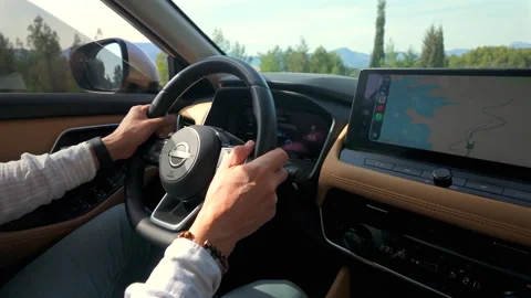 Driver using Nissan X Trail e Power hybrid vehicle navigation system Stock Footage 337197594