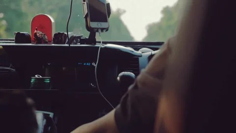 Driver using phone while sitting behind steering wheel. Technology and Stock-Footage 336266763