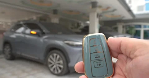 Driver is using the remote key to unlock the modern car. Stock Footage 276906063