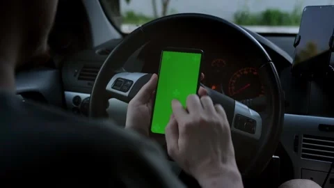 Driver using a smartphone inside the car in the twilights. Stock Footage 247281157