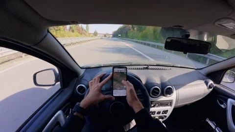 Driver Using Smartphone Map While Driving on Highway, POV in Autumn 库存影片 348731493