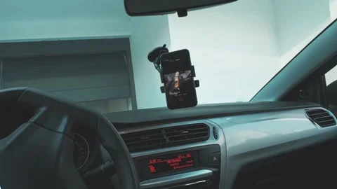 Driver using smartphone navigation while driving Stock Footage 321436074