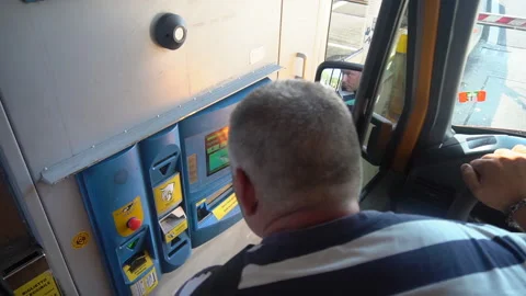 Driver in the van tries to pay for the toll road in Italy with credit card - FHD Stock Footage 179342217