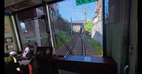 Driver view of Japan's century-old Randen tram moving on tracks in Kyoto Stock Footage 337073566