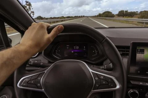 Driver view to the speedometer at 119 kmh, on a road blurred. Stock Photos
