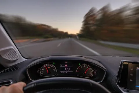 Driver view to the speedometer at 89 km h, driver POV of the road landscape. Stock Photos