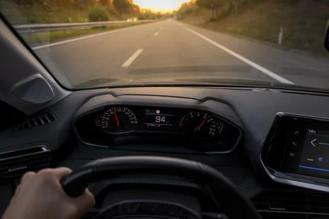 Driver view to the speedometer at 94 kmh or 94 mph, on a road blurred in motion. Stock Photos