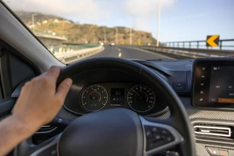 Driver view to the speedometer, with hand on steering wheel. Madeira, Portugal. Stock Photos