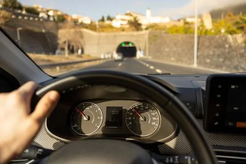 Driver view to the speedometer, with hand on the steering wheel. Stock Photos