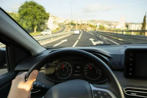 Driver view to the speedometer, with hand on the steering wheel. Stock Photos