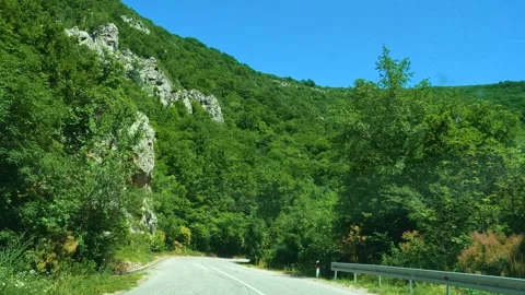 Driver views winding road through green hills. Mount Rtanj Area, Serbia Stock Footage 340897434