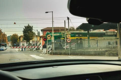 Driver is waiting for a train to pass behind the gates Stock Photos