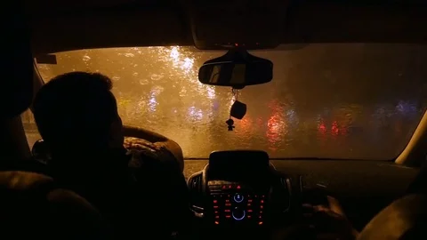 The driver waits in the car when the rain ends. Alone sad driver Stock Footage 82739918