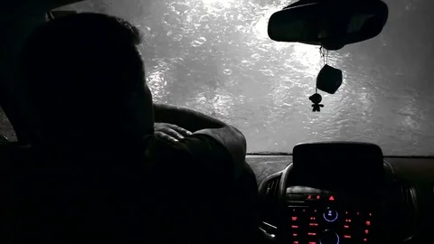The driver waits in the car when the rain ends. Black and white Stock Footage 82741709