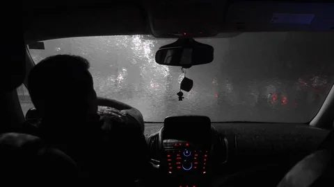 The driver waits in the car when the rain ends. Black and white Stock Footage 82741712