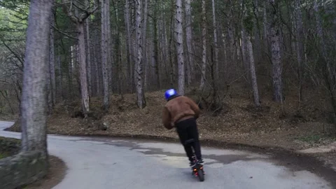 A driver wearing a protective helmet and a powerful electric scooter drives Stock Footage 153057230