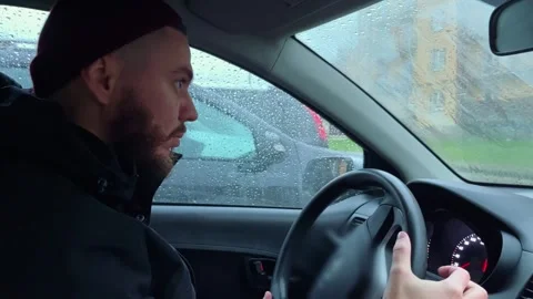 The driver wipes the windshield on the car from raindrops Stock Footage 253817901