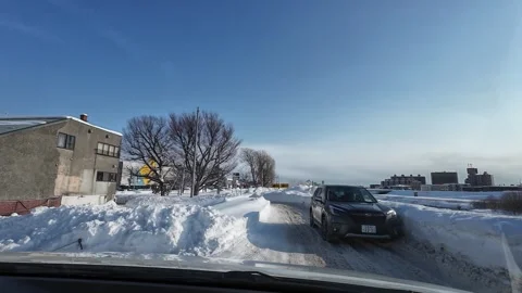 Driver yields based on road condition narrow snowy road Sapporo Stock Footage 333229692