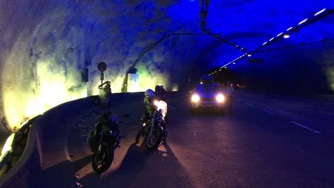 Drivers and motorcyclists stop inside of Laerdal tunnel for watching interior Stock Footage 101976869