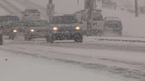 Drivers and traffic in heavy snow on highway and roads in cold winter Stock Footage 47156472